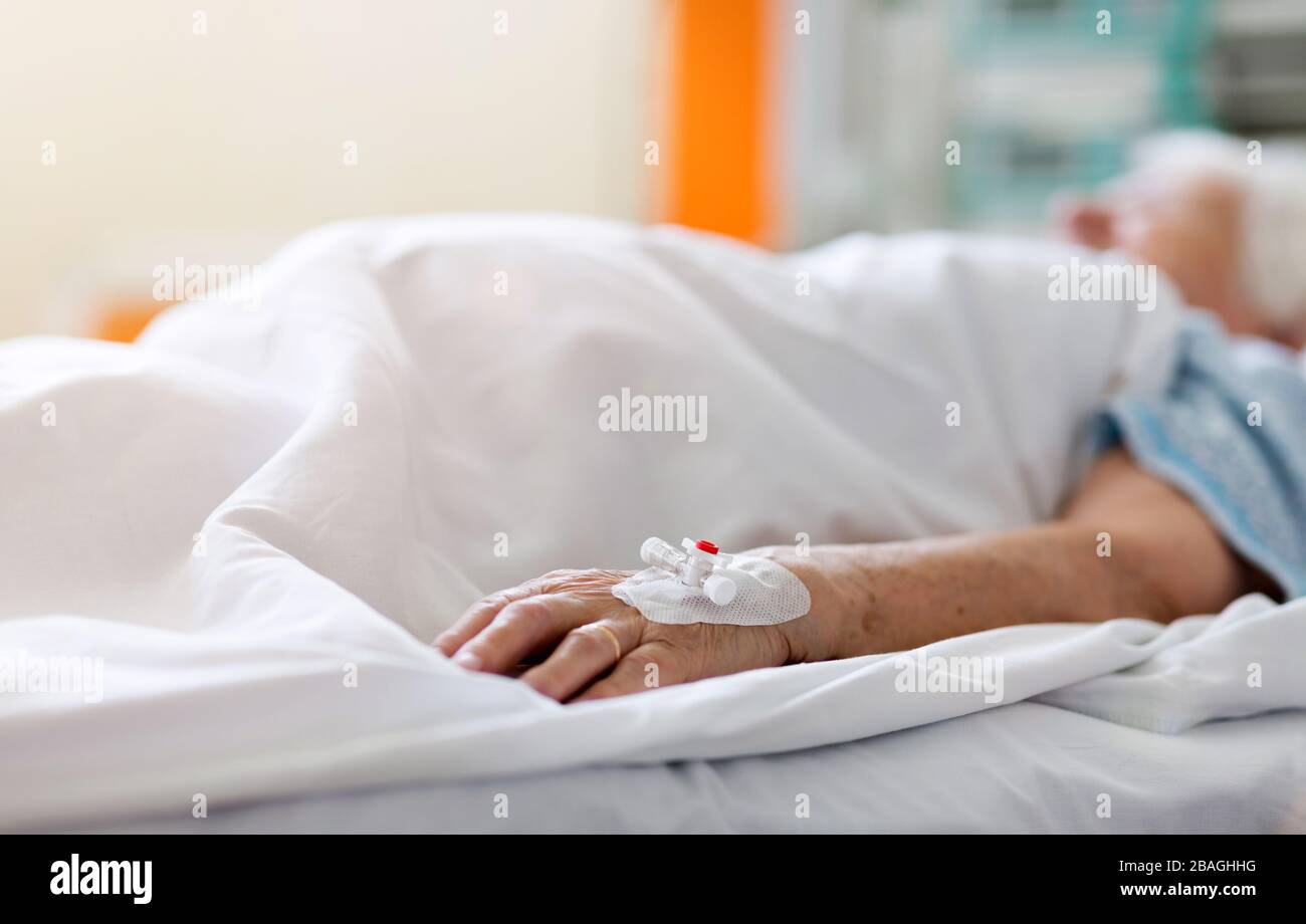 Senior patient in hospital bed Stock Photo
