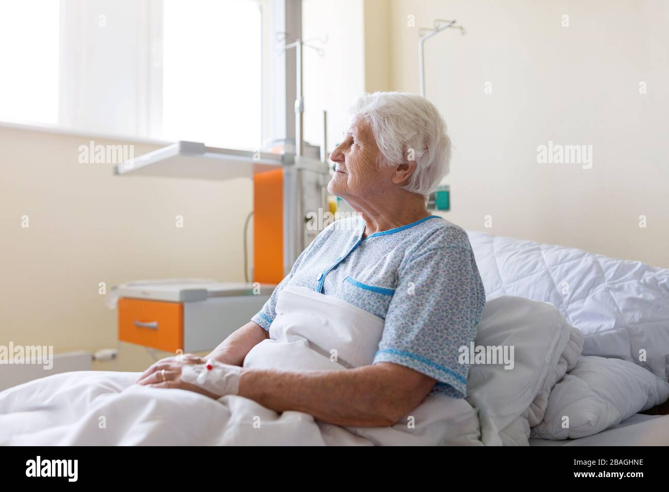 Senior patient in hospital bed Stock Photo