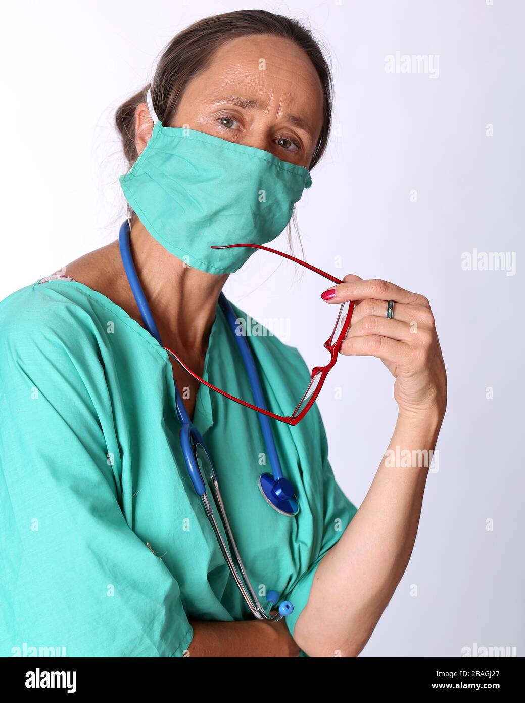 August 2015 - Older lady doctor returning to duty to serve too assist with the treatment of Coronavirus patients Stock Photo