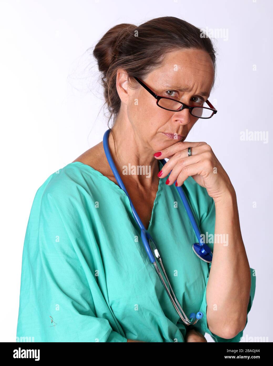 August 2015 - Older lady doctor returning to duty to serve too assist with the treatment of Coronavirus patients Stock Photo