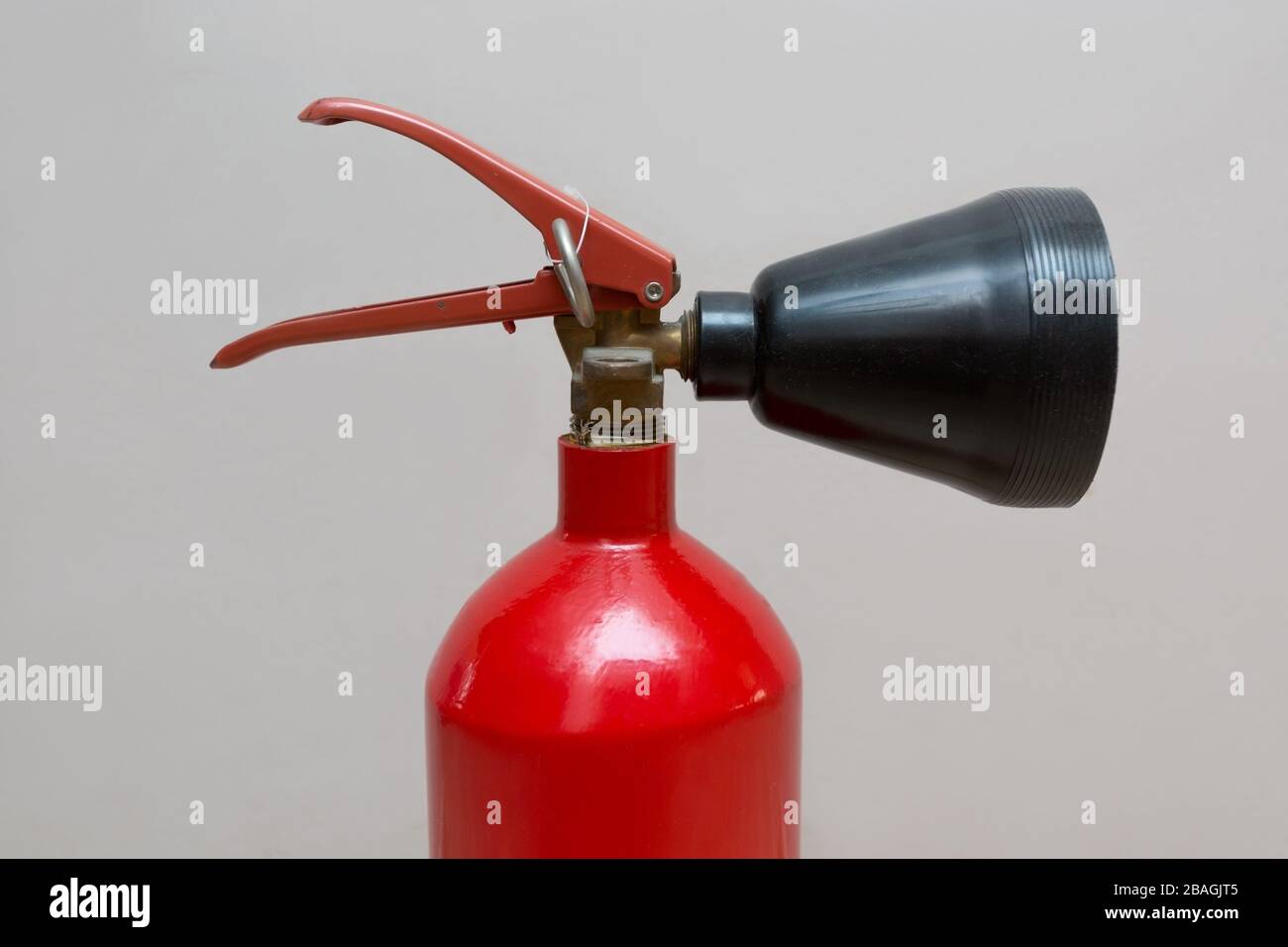 Home Fire Extinguisher with Red Base and Black Nozzle Stock Photo