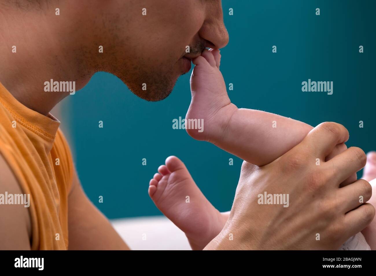 Emotional dad kissing his brand new baby’s foot Stock Photo