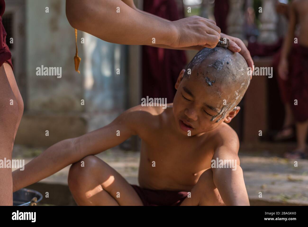 Monks shaving, Bagan, Myanmar Stock Photo