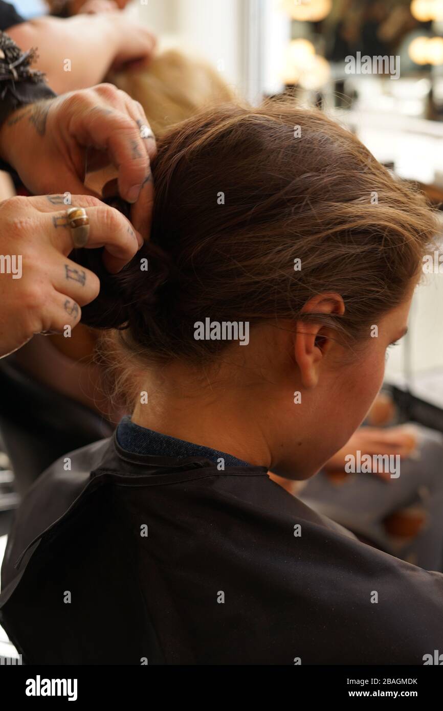 Man styling young girl's hair during New York Fashion Week. Stock Photo