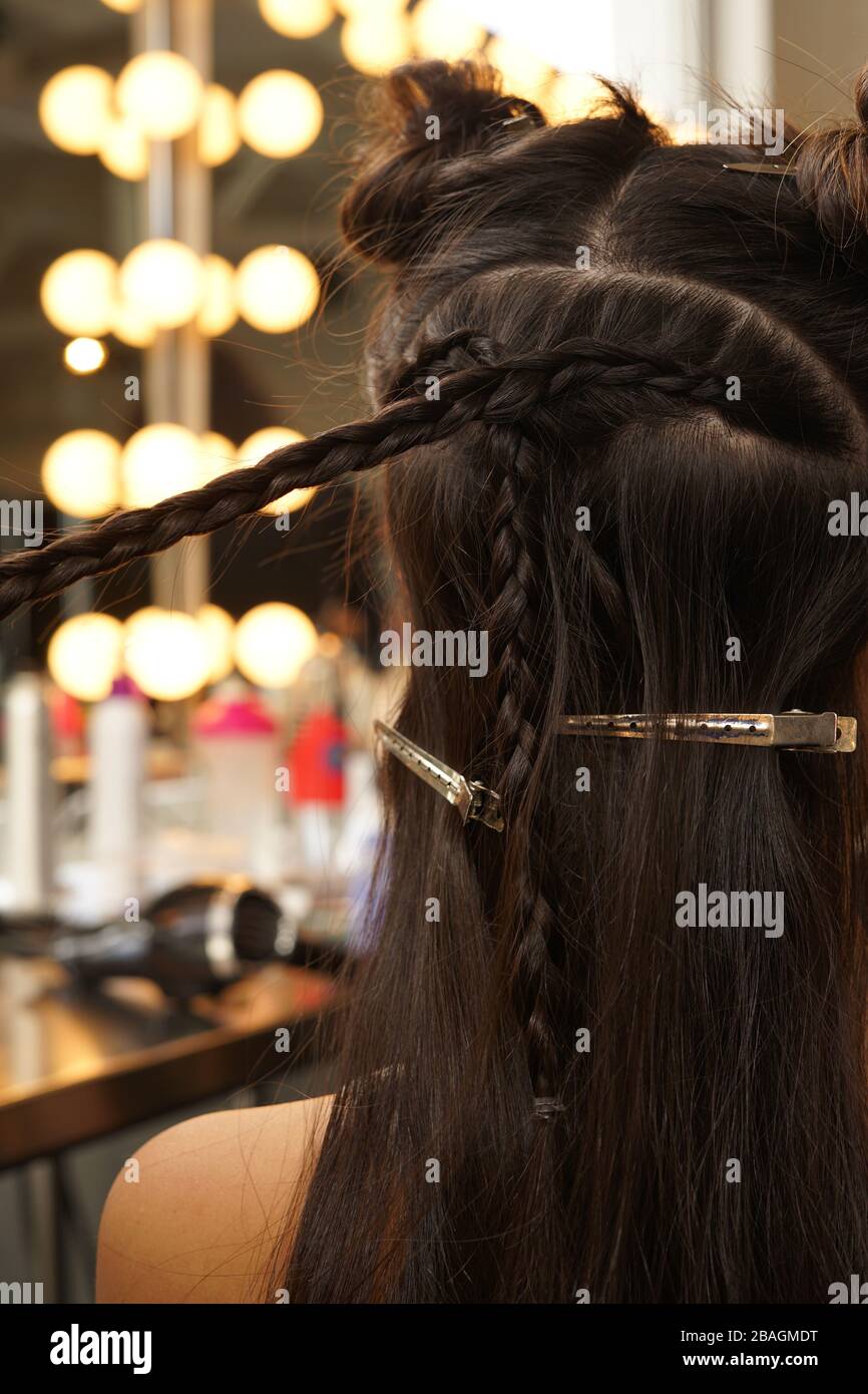 Styling a young brunette girl's hair, backstage of NYFW Stock Photo