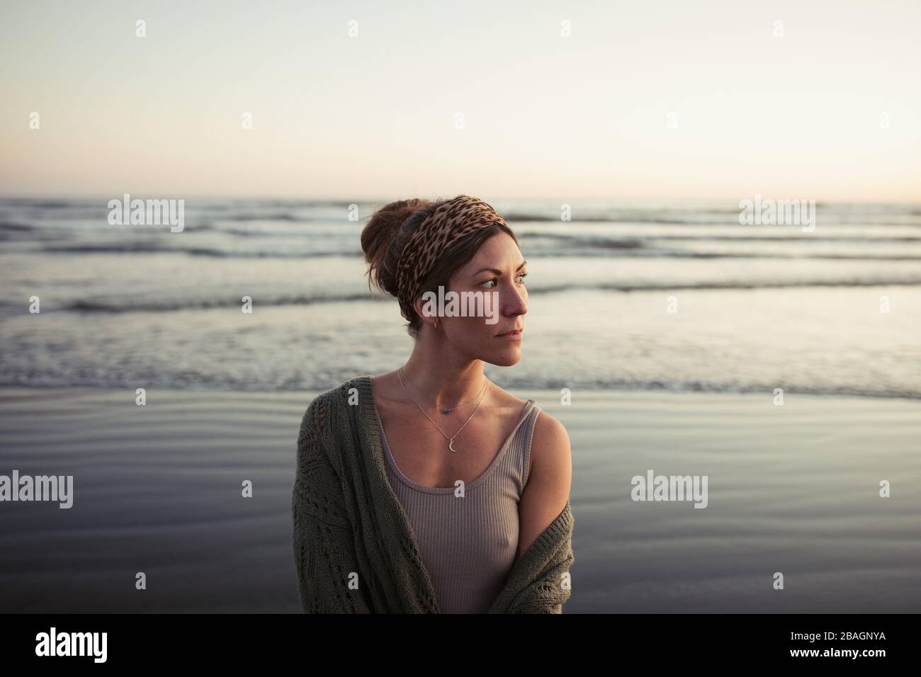 Beautiful woman on Long Beach at sunset in Tofino Stock Photo