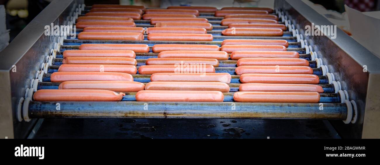 Hot dogs on a grill  at an outdoor event. Stock Photo