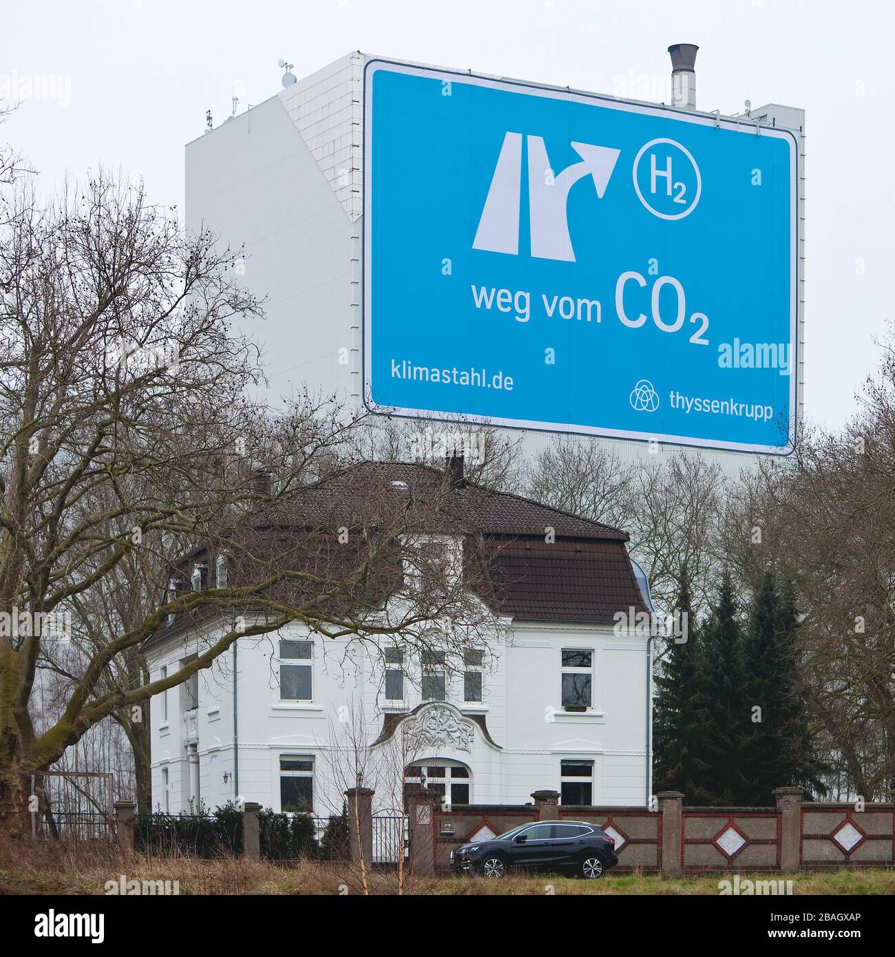 large-format poster near the motorway A 40, from CO2 to H2, Klimastahl, factory hall of ThyssenKrupp Steel Europe, Germany, North Rhine-Westphalia, Ruhr Area, Bochum Stock Photo