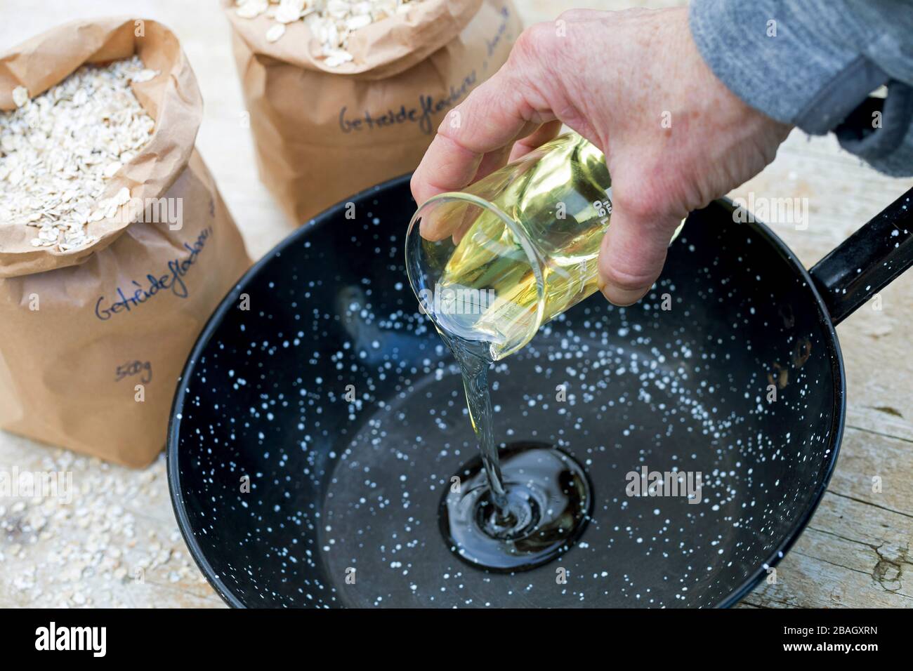 making bird seed with cereal and oil, series picture 2/4 Stock Photo