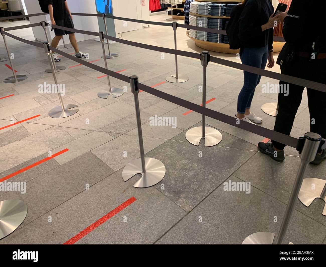 The Uniqlo flagship store implements social distancing on March 27, 2020 in  Orchard Road in Singapore. Singapore introduced fines and potential jail  sentences for people ignoring social distancing guidelines. Before entering  this