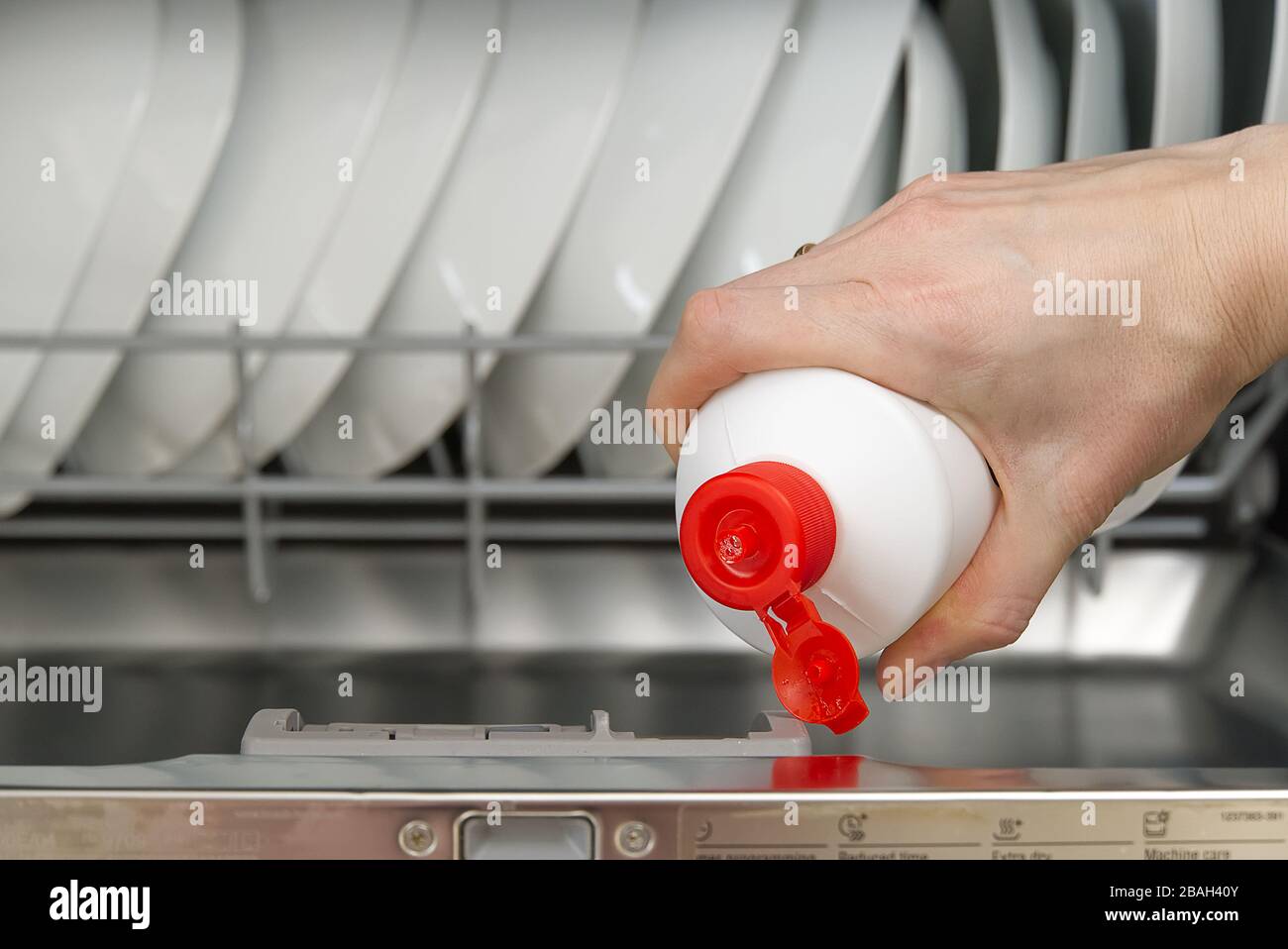 Putting tab into full dishwasher close up. integrated dishwasher