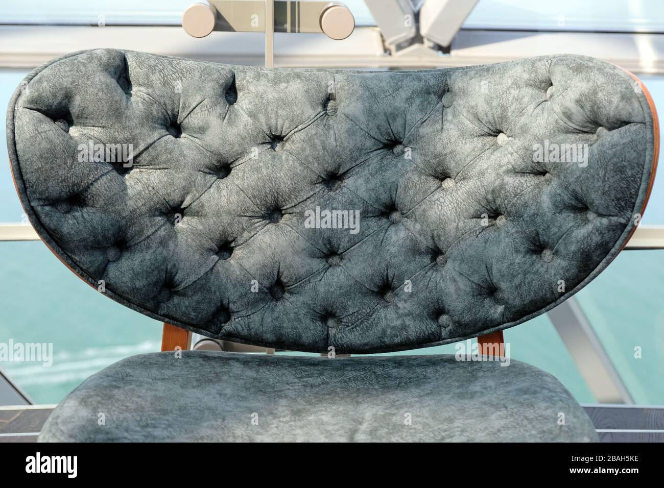The stylish soft chair sheathed by fabric of green color. Fashionable new furniture for a modern interior. Stock Photo