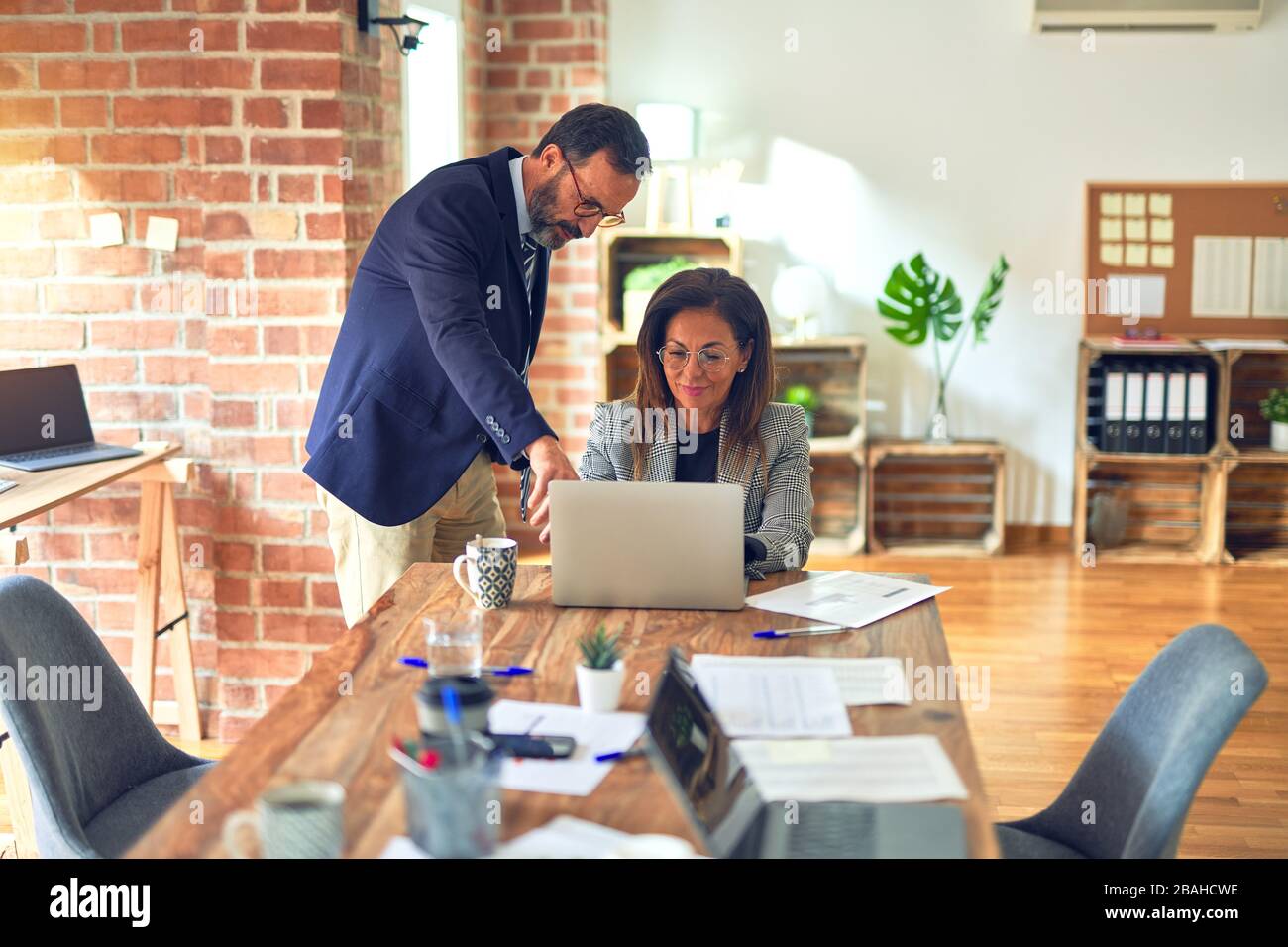 Two middle age business workers smiling happy and confident. Working ...