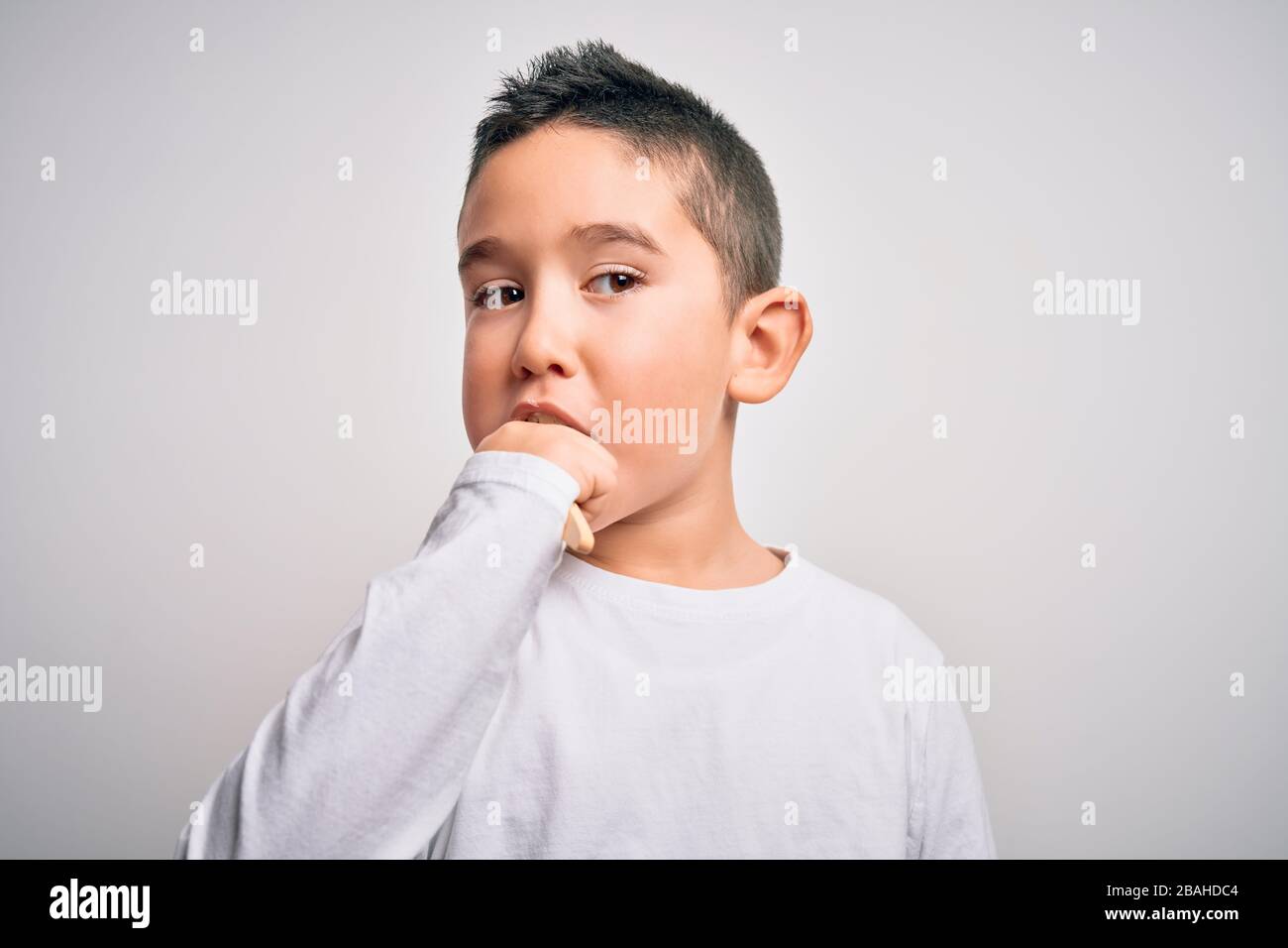 Young little kid boy brushing her teeth using tooth brush and oral paste, cleaning teeth and tongue as healthy health care morning routine. Learning d Stock Photo