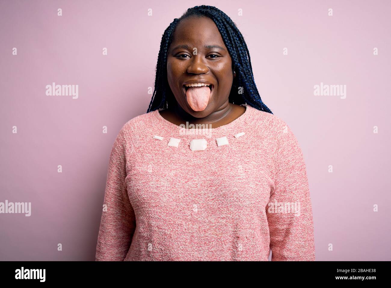 African american plus size woman with braids wearing casual sweater ...