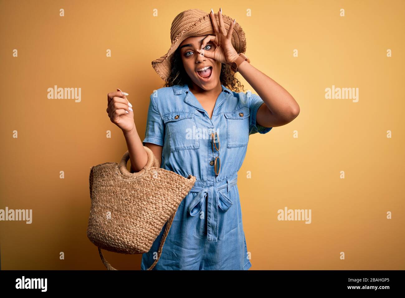 Young african american tourist girl on vacation wearing summer hat and ...