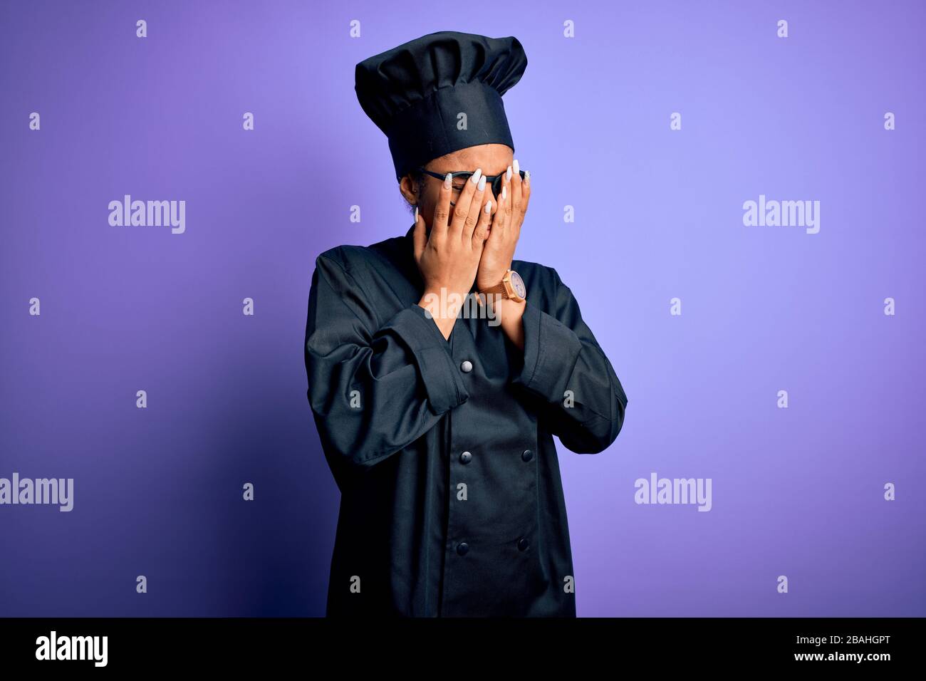 Young african american chef girl wearing cooker uniform and hat over purple background rubbing eyes for fatigue and headache, sleepy and tired express Stock Photo