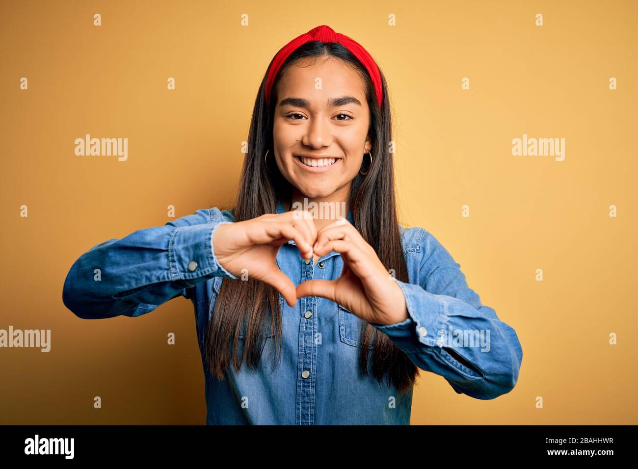 Young beautiful asian woman wearing casual denim shirt and diadem over ...