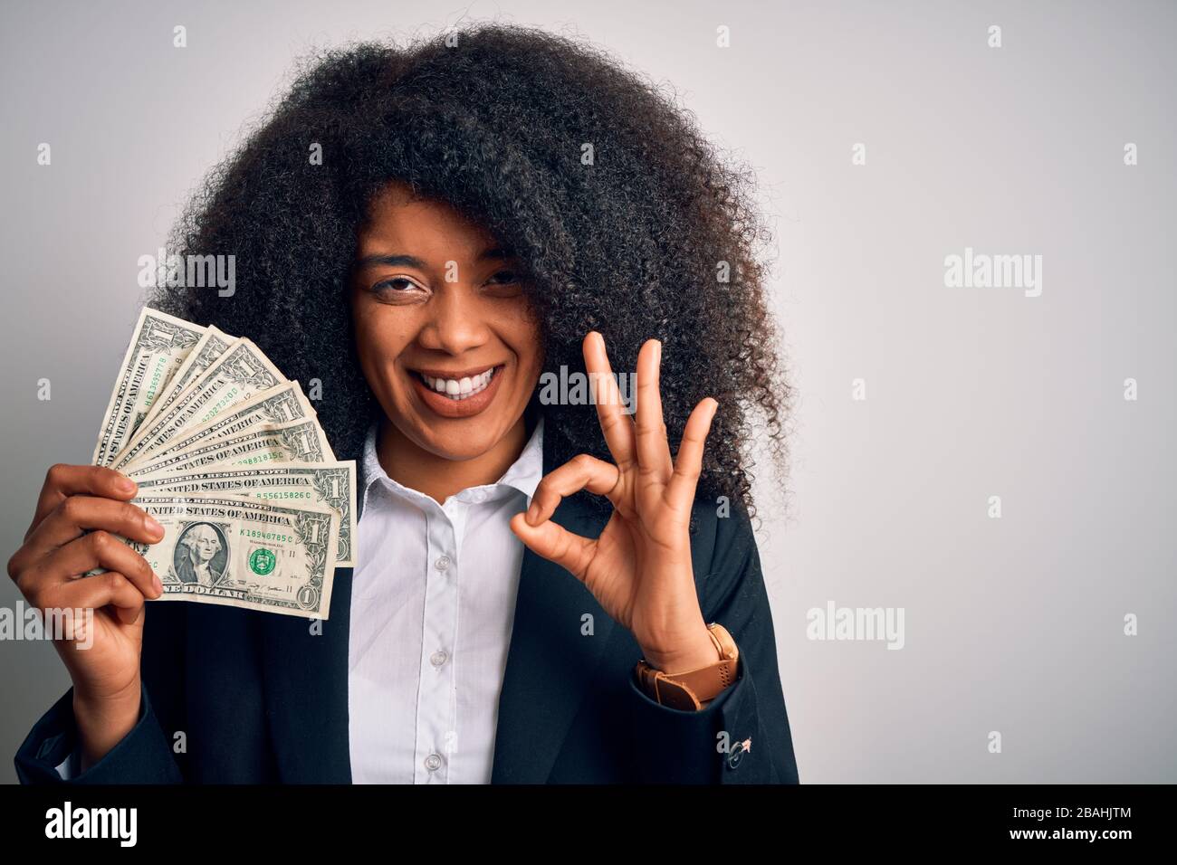 Young african american business woman with afro hair holding cash ...