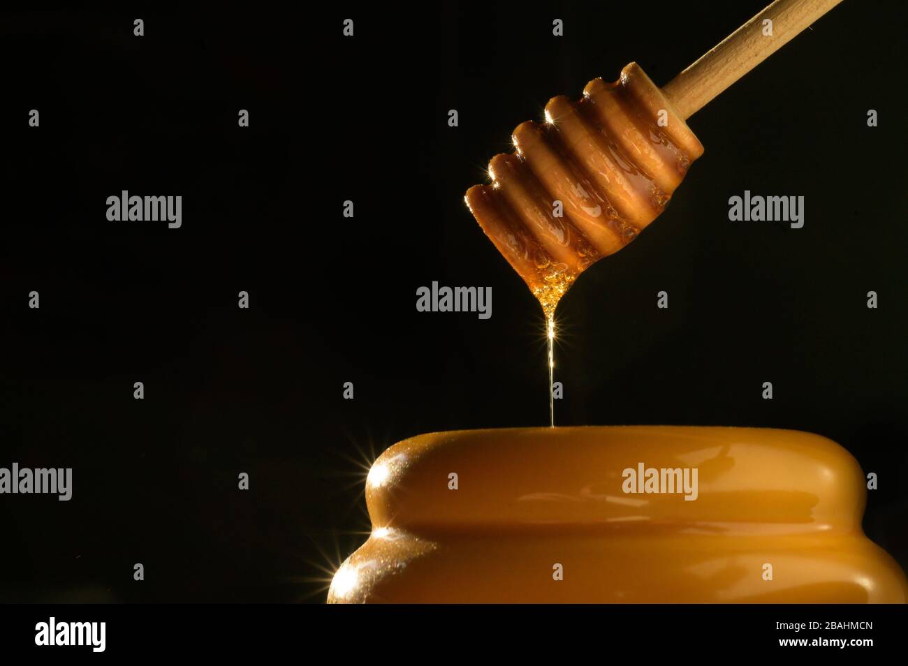 Tasty Dripping Honey pot photography - Low Key food images - high-quality food photos - Product photography Stock Photo
