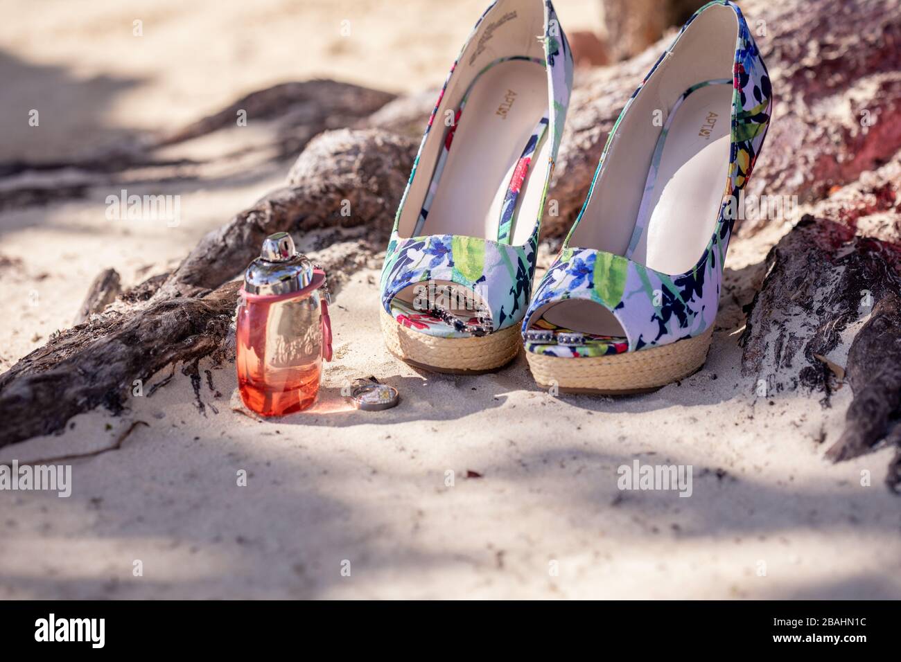 Wedding item splay at an exotic resort in Jamaica, including perfume, shoes, and wedding bands Stock Photo