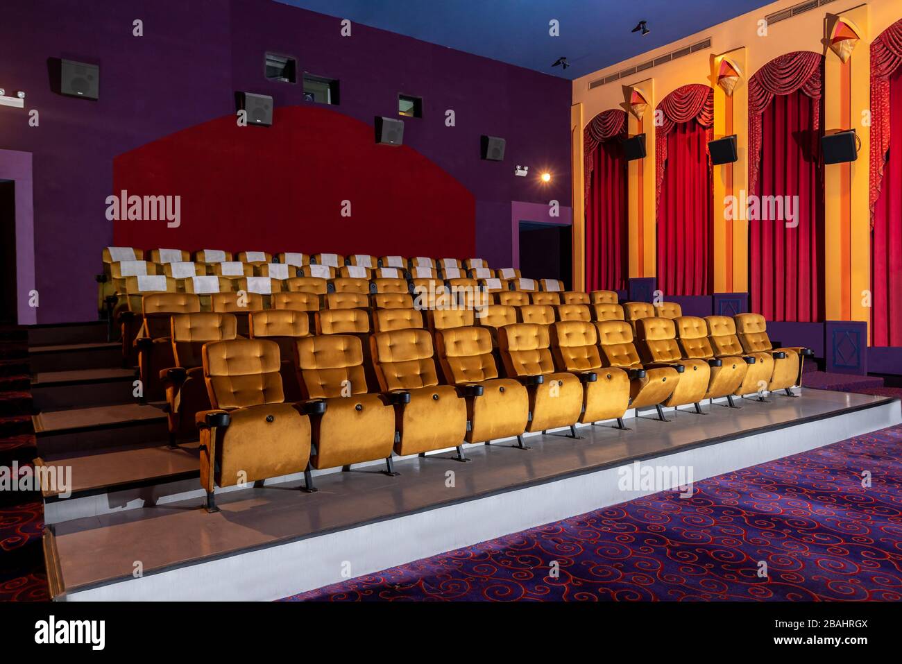 Large cinema theater interior with seat rows for audience to sit in