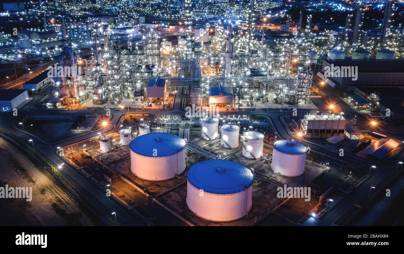 Large industrial estates of oil and gas refinery, Aerial view of industry plants, oil storage tanks and pipeline at night Stock Photo