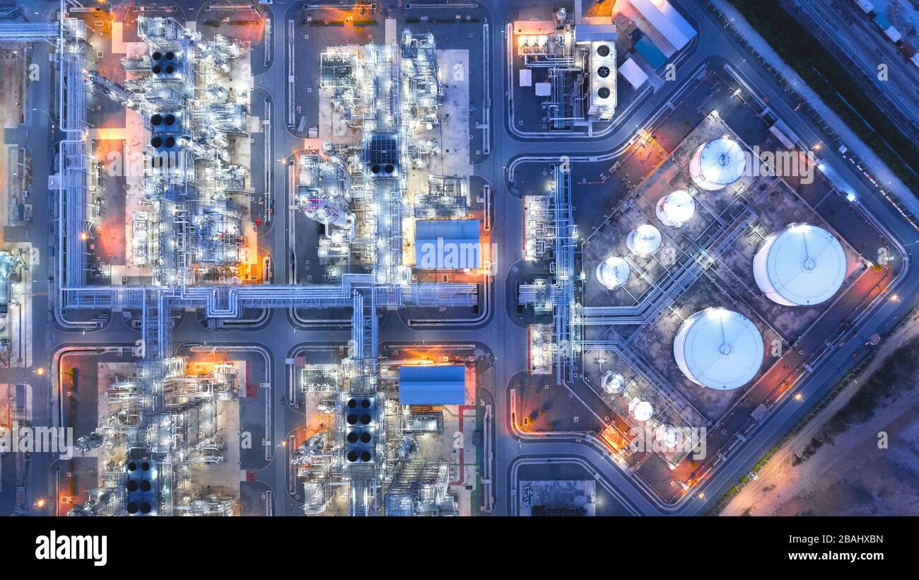 Large industrial estates of oil and gas refinery, Aerial view of industry plants, oil storage tanks and pipeline at night Stock Photo