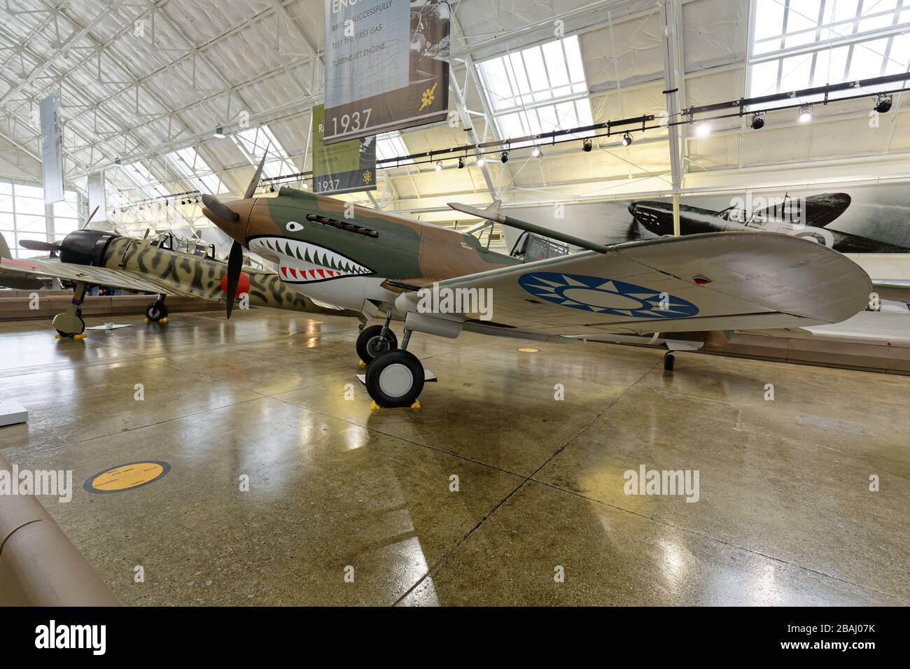 SEPTEMBER 19, 2015, EVERETT, WA: Wide shot of a Curtiss P-40C Tomahawk on display at a Seattle-area museum, seen with its nemesis, a Japanese Zero. Stock Photo