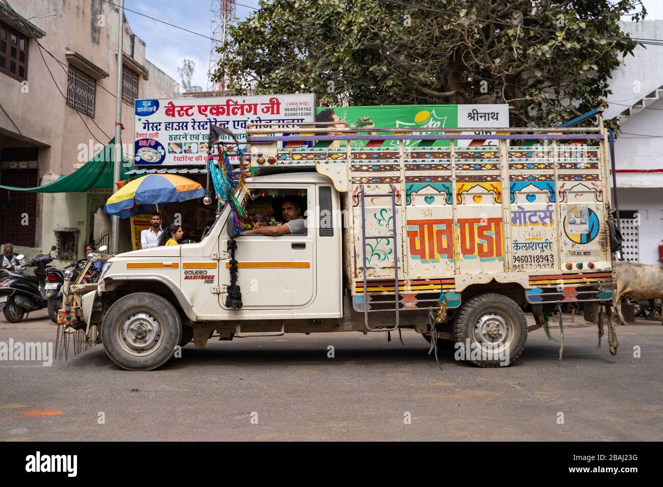 Eklingji, India March 15, 2020 Colorful, hand painted truck passes through the village