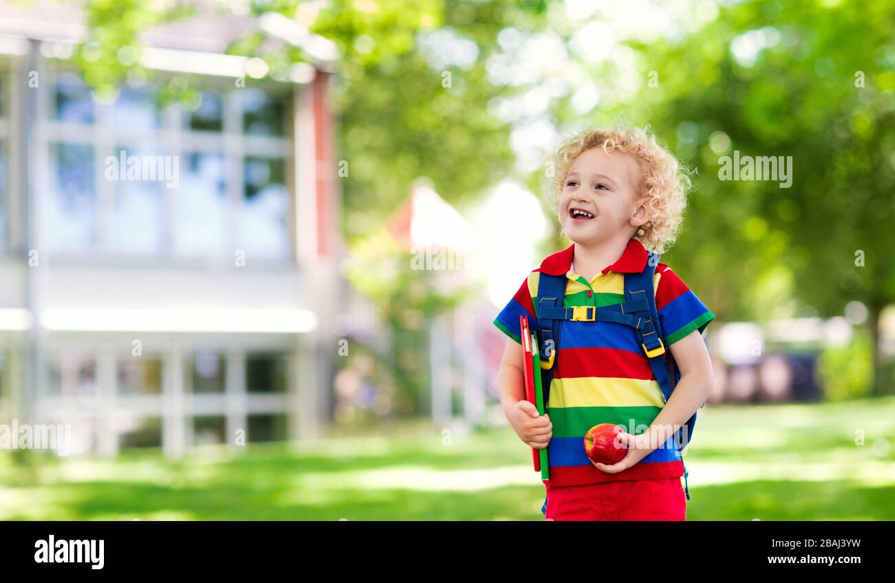 Child going back to school. Start of new school year after summer vacation. Little boy with backpack and books on first school day. Beginning of class Stock Photo