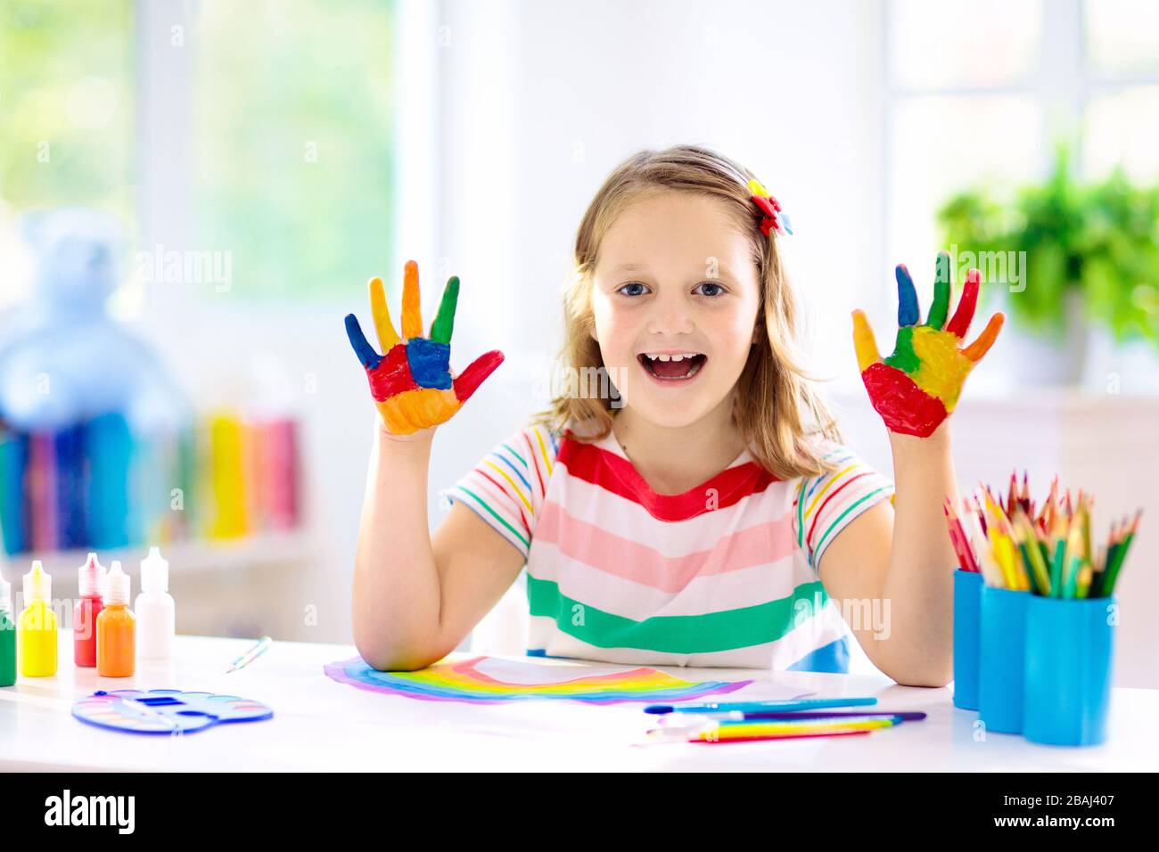 Kids paint. Child painting in white sunny study room. Little boy