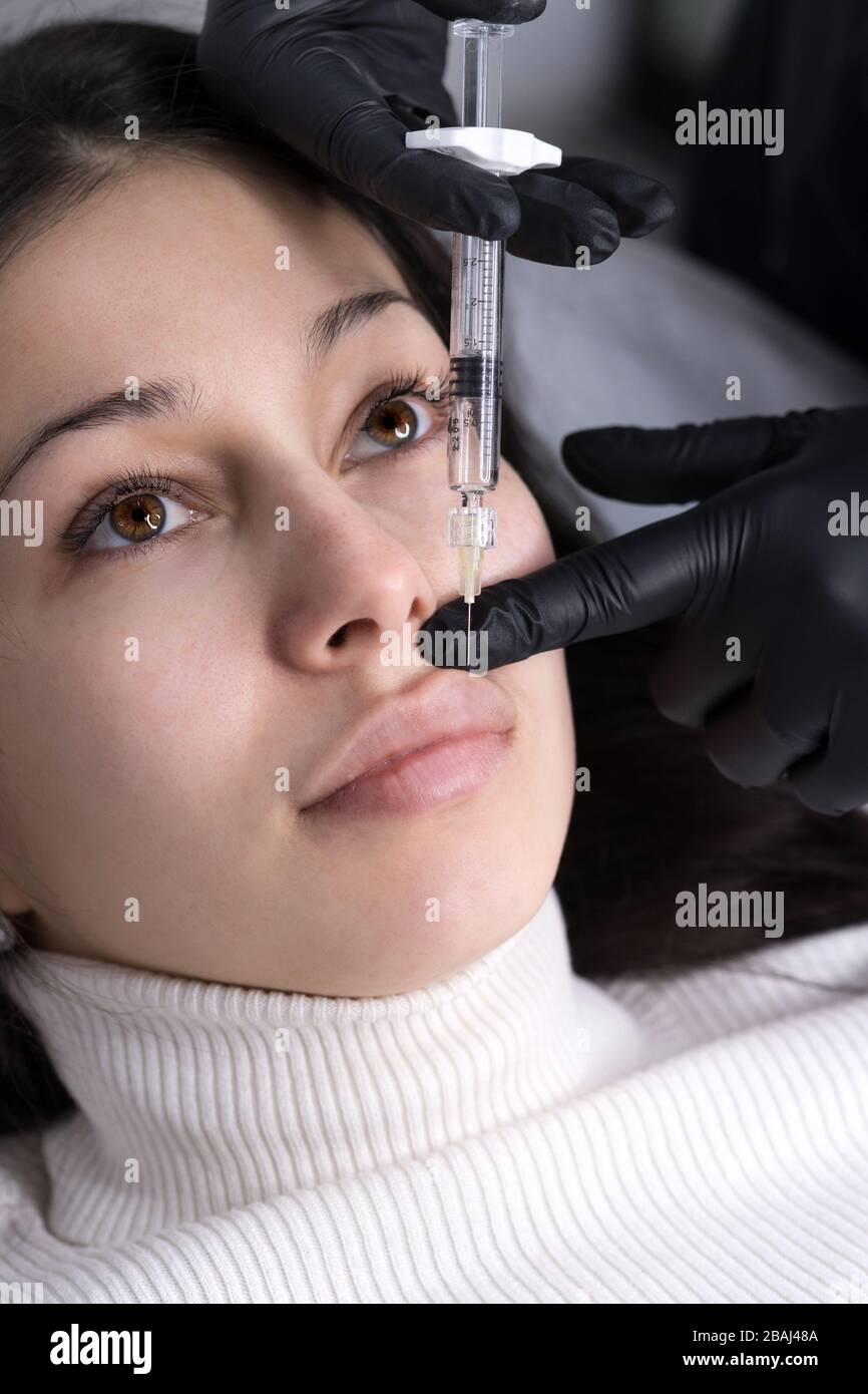 Injections of the lips. Adjustment of the lower lip form. Injection of ...