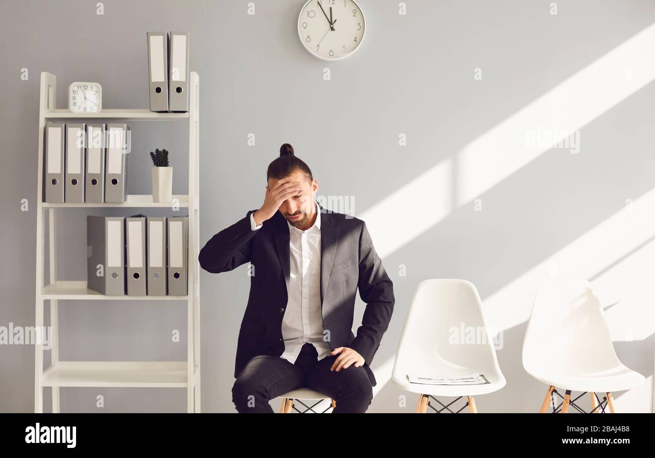 Unemployed man in gray office. Unemployment. Crisis. Stock Photo