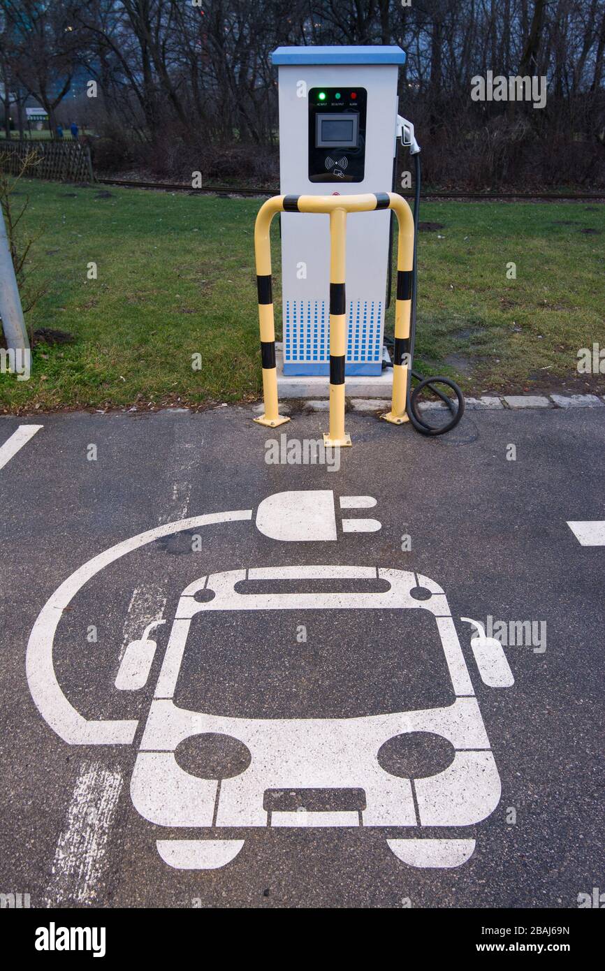 Electric vehicle charging station sign in a parking bay Stock Photo