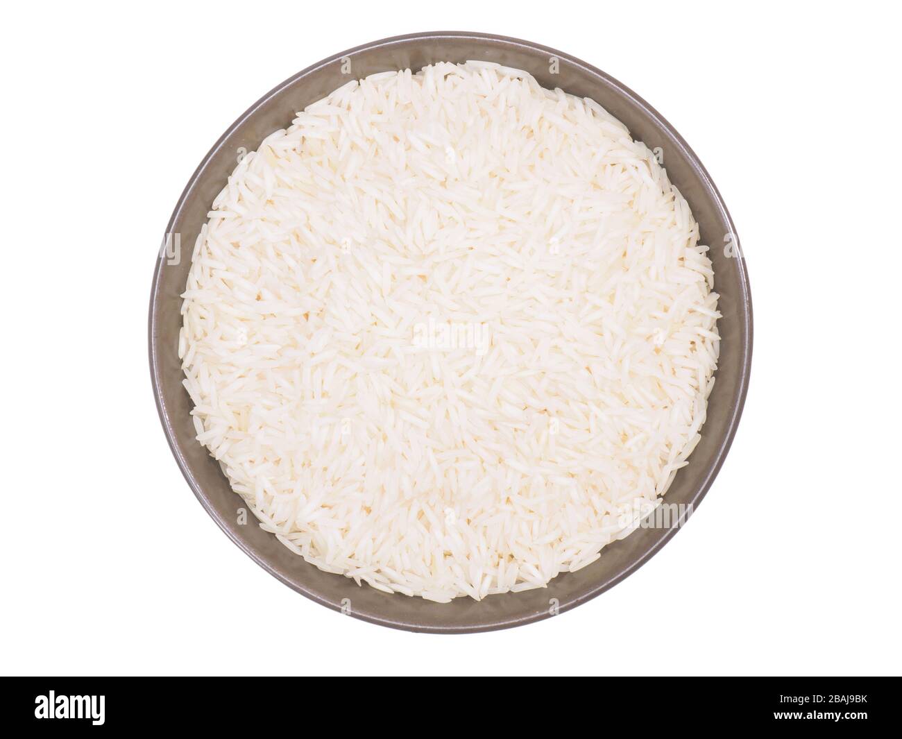 Indian long grain Basmati rice in brown ceramic bowl isolated on white. Indian cuisine, ayurveda