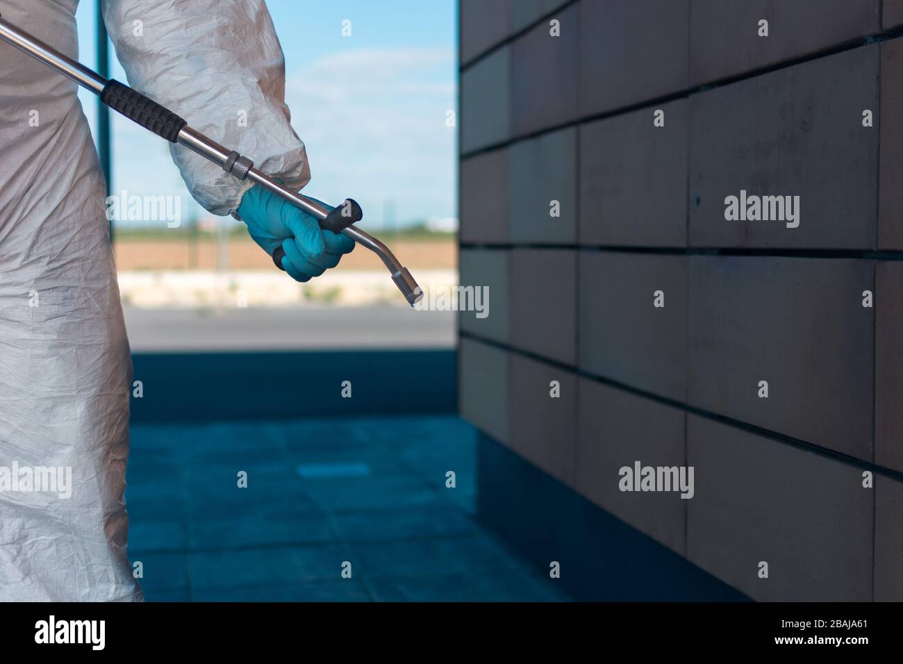 Hand, arm and spear. Man wearing an NBC personal protective equipment