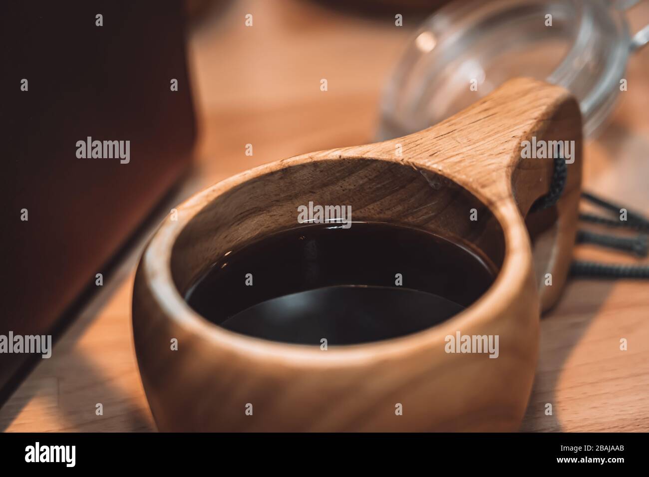 Wooden mug with black coffee Stock Photo