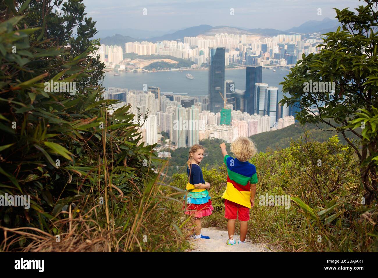 Family with kids hiking in Hong Kong mountains. Beautiful landscape