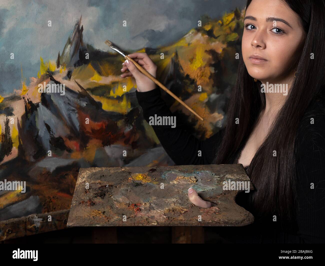 Young woman painting a canvas on an easel Stock Photo - Alamy