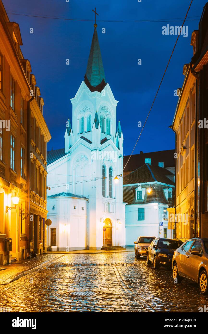 Riga Latvia. White Tower With Pyramidal Spire Of Our Lady Of Sorrows Or Virgin Of Anguish Church. Stock Photo