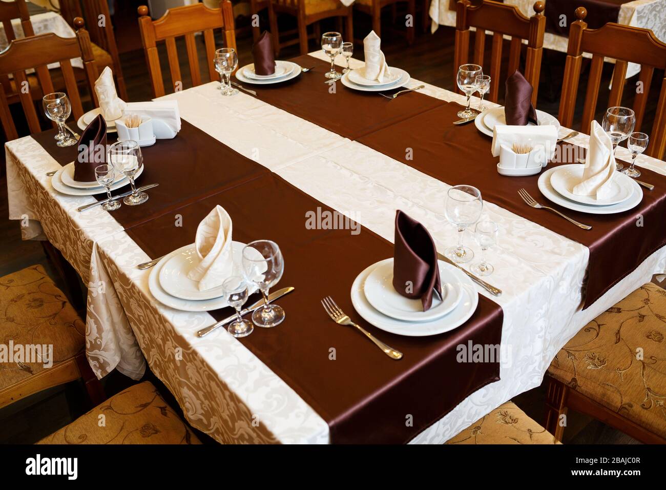 Table setting in a restaurant. Glass, plate, fork, knife Stock Photo