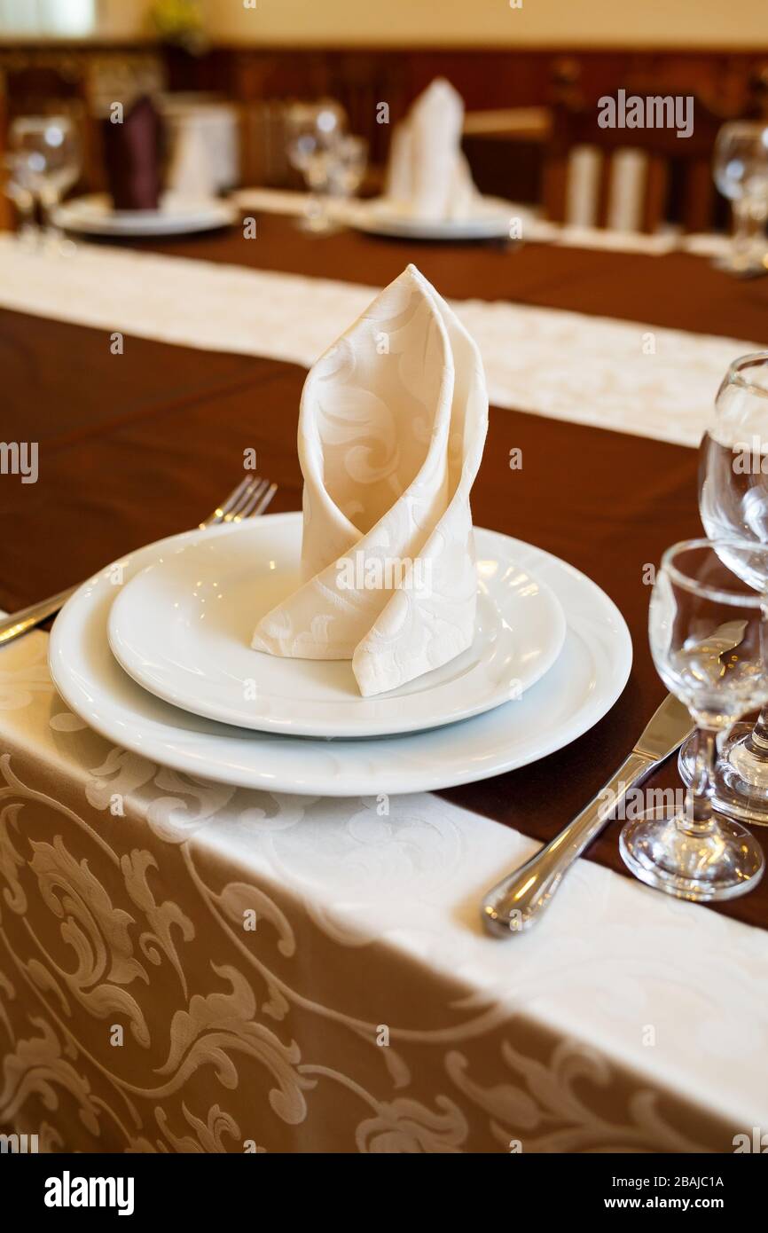 Table setting in a restaurant. Glass, plate, fork, knife Stock Photo