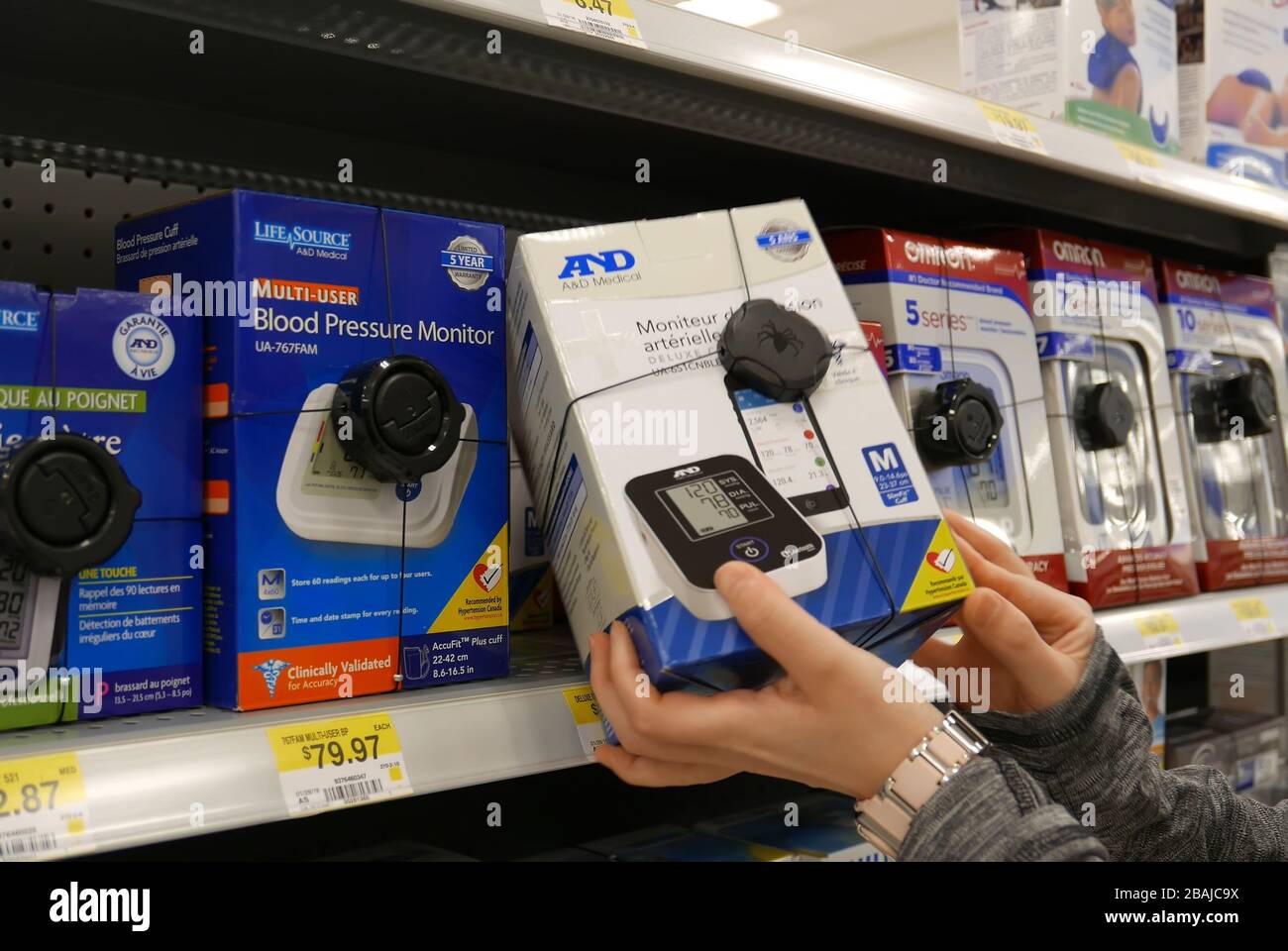 Woman taking A&D blood pressure monitor inside Walmart store Stock Photo