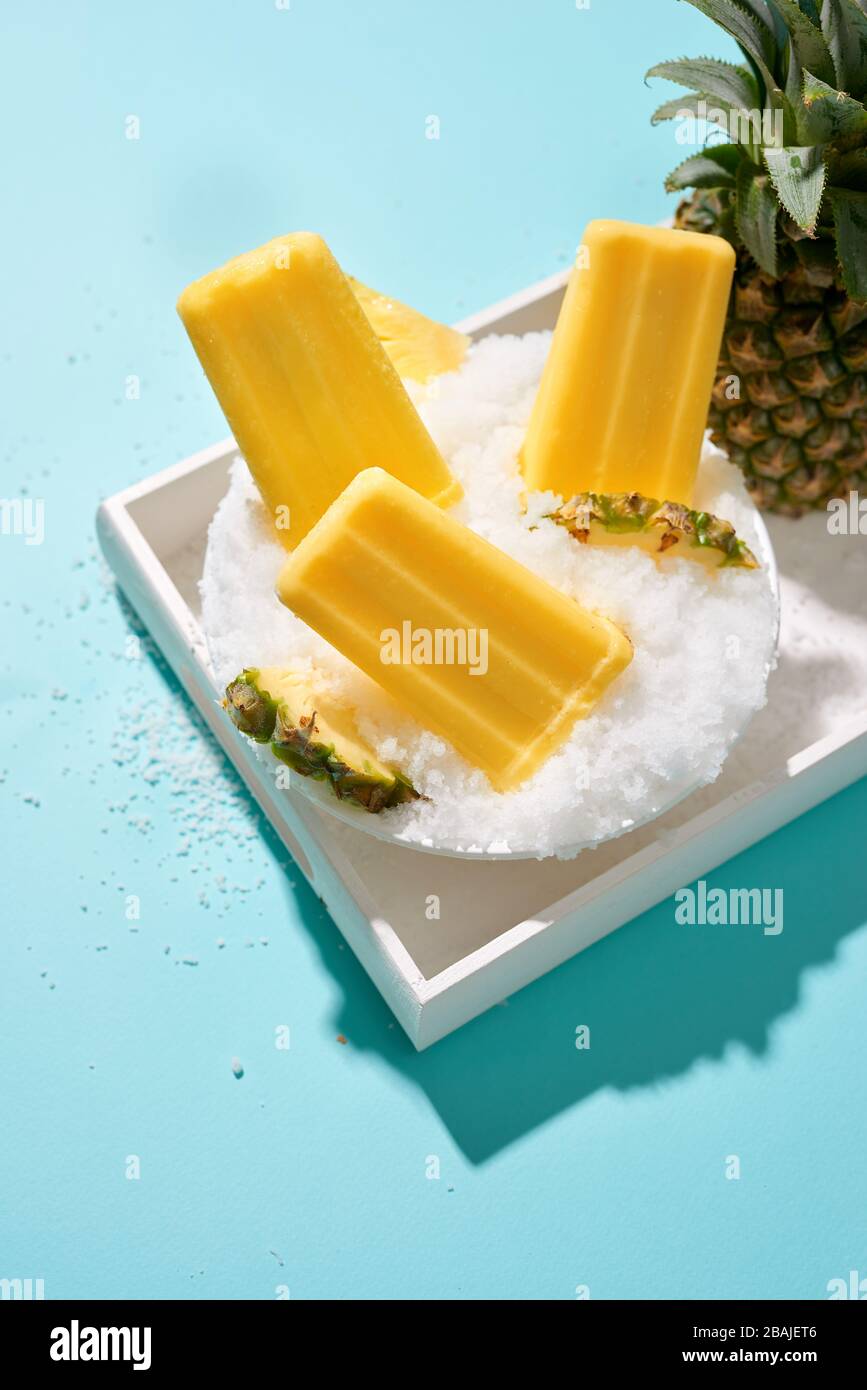 Fruit pineapple ice cream on a stick. Bright color, summer mood Stock