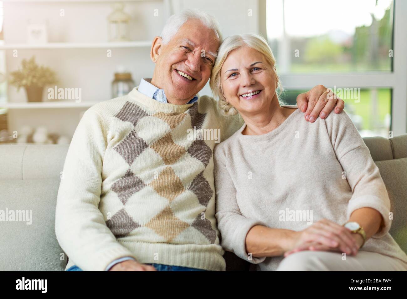 Happy senior couple relaxing together in their home Stock Photo - Alamy