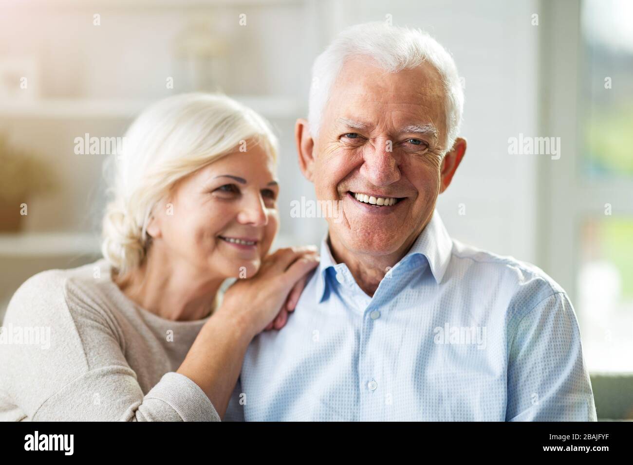 Happy senior couple relaxing together in their home Stock Photo - Alamy