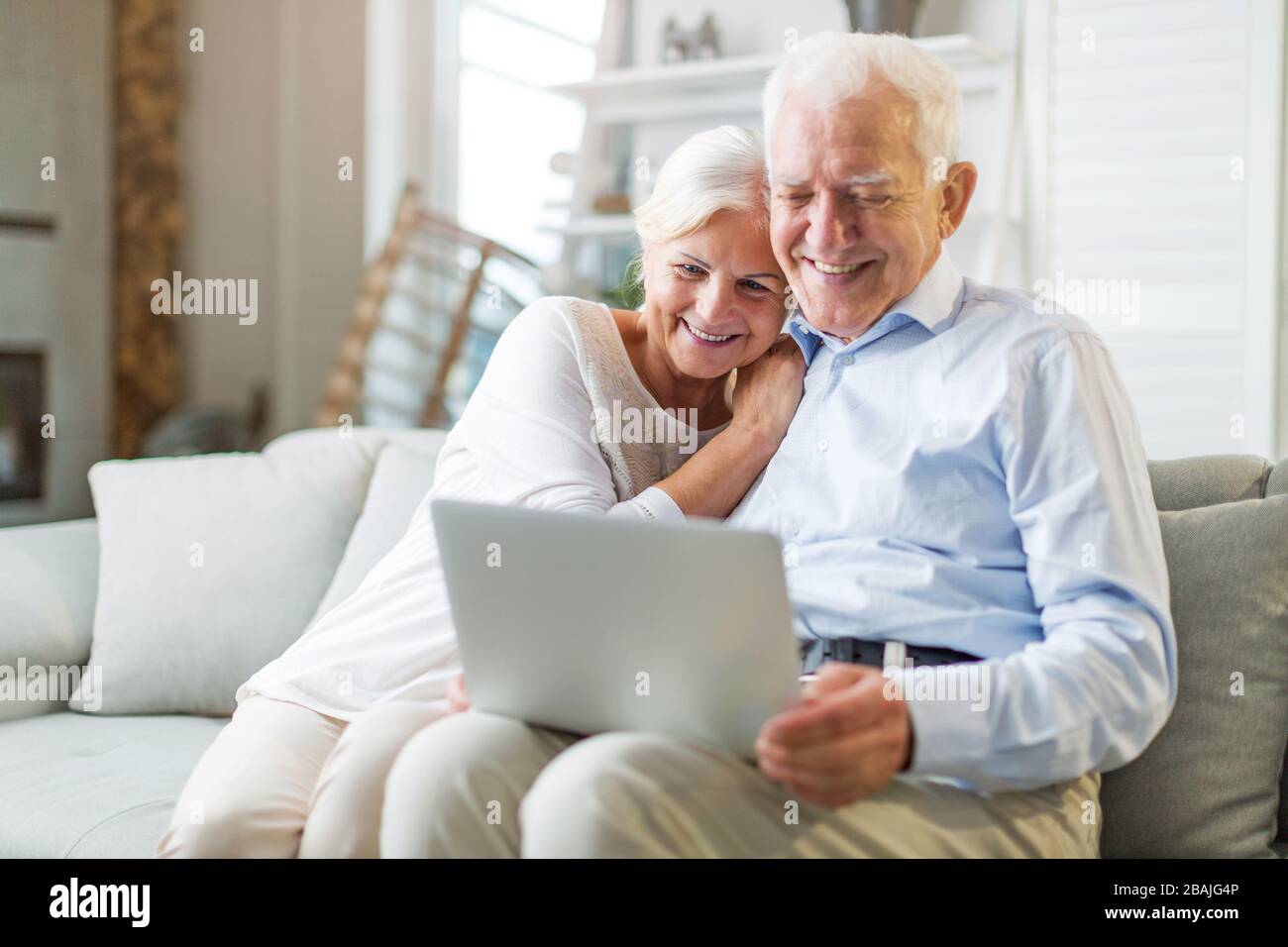 Happy senior couple relaxing together in their home Stock Photo - Alamy