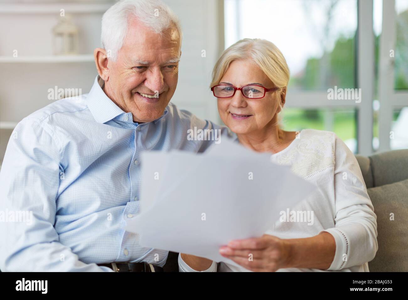 Happy senior couple relaxing together in their home Stock Photo - Alamy