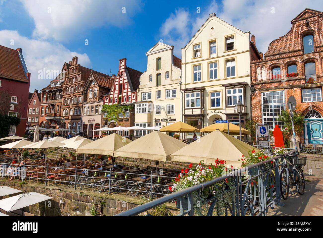 Lüneburg, Germany – 09. August 2017: Cafes and restaraunts in Lüneburg's old town. The street name is 'Stintmarkt' in the “Wasser-Viertel” district. T Stock Photo